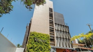 A modern building with a 'Sense' sign, a vertical garden, and a motorcycle parked in front. - Beachfront Condo Studios With Pool in Bessa Beach - Gses (João Pessoa)