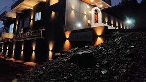 A modern building with a sign reading "OCEANUS" at the base. - Casa Oceanus - 3 Bedroom - Sea Facing Pool Villa - Ganpatipule - Ratnagiri (Ganpatipule - Ratnagiri)