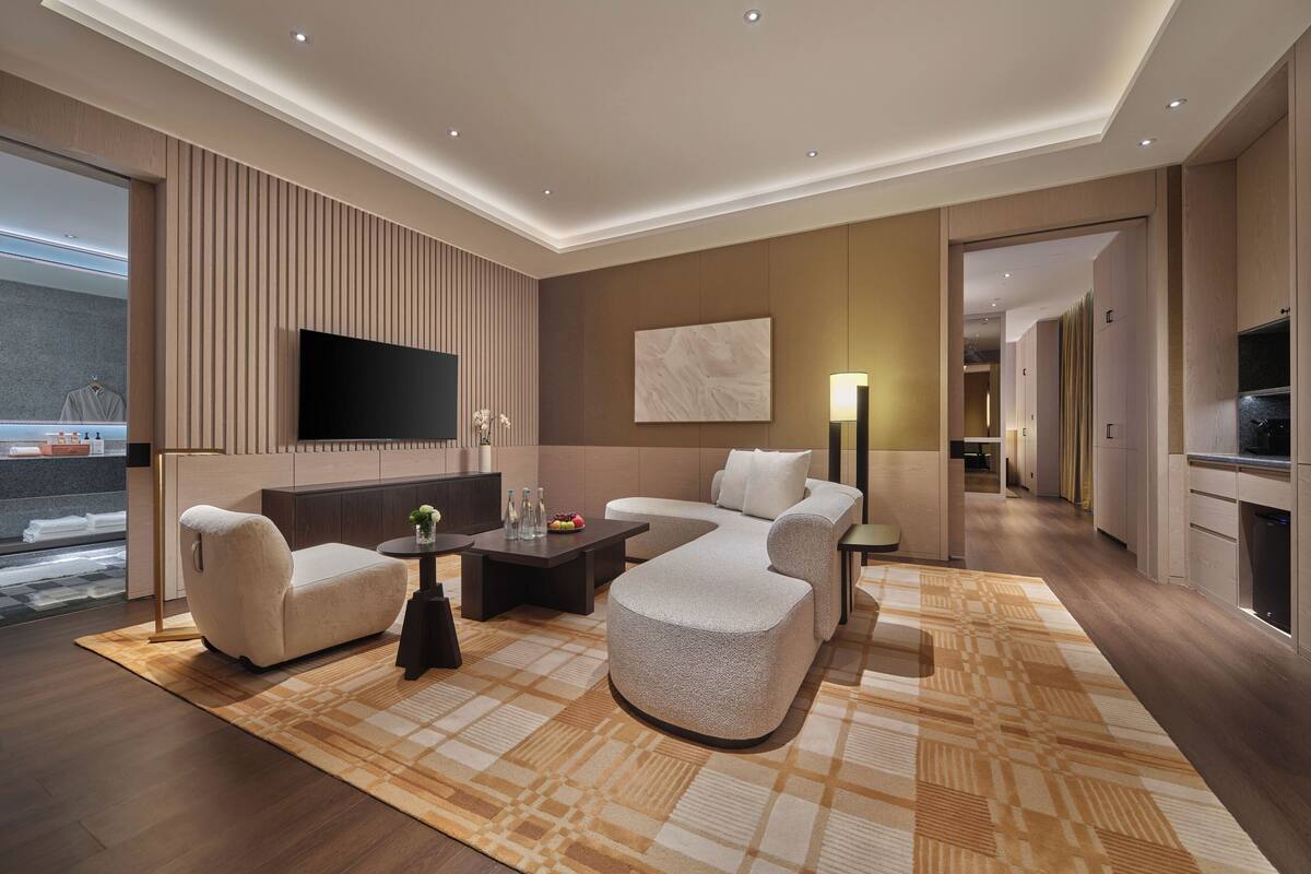 Deluxe Suite, 2 Bedrooms | Living area | 65-inch LED TV with cable channels, heated floors