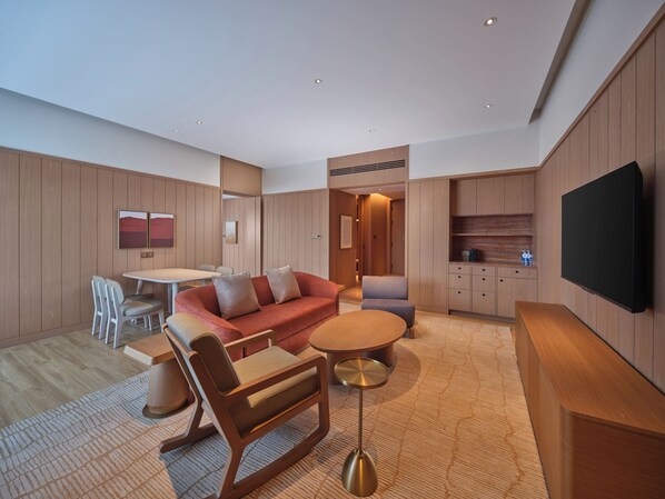 Deluxe Suite, 1 King Bed | Living area | 65-inch LED TV with cable channels, heated floors - Hilton Altay Hemu (Burqin)