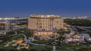 A modern hotel with a central courtyard, multiple floors, and a waterfront view. - Canopy By Hilton Okinawa Miyako Island Resort (Miyakojima)
