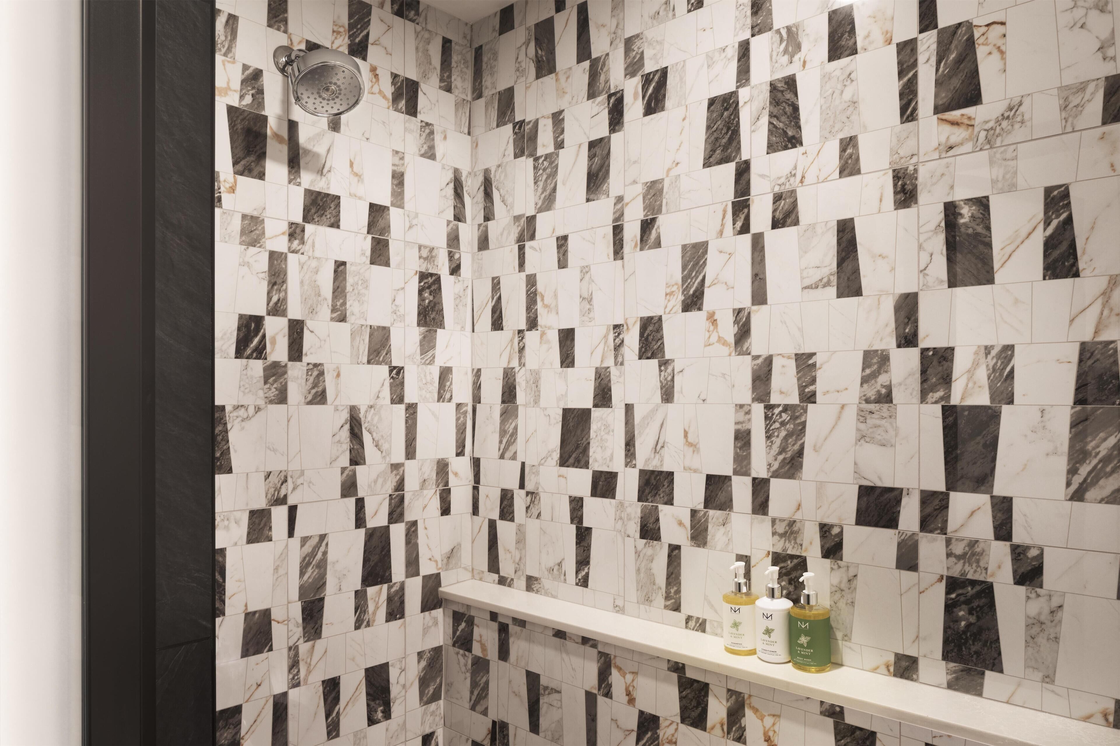 A bathroom with a checkered tile pattern and a shelf with toiletries.