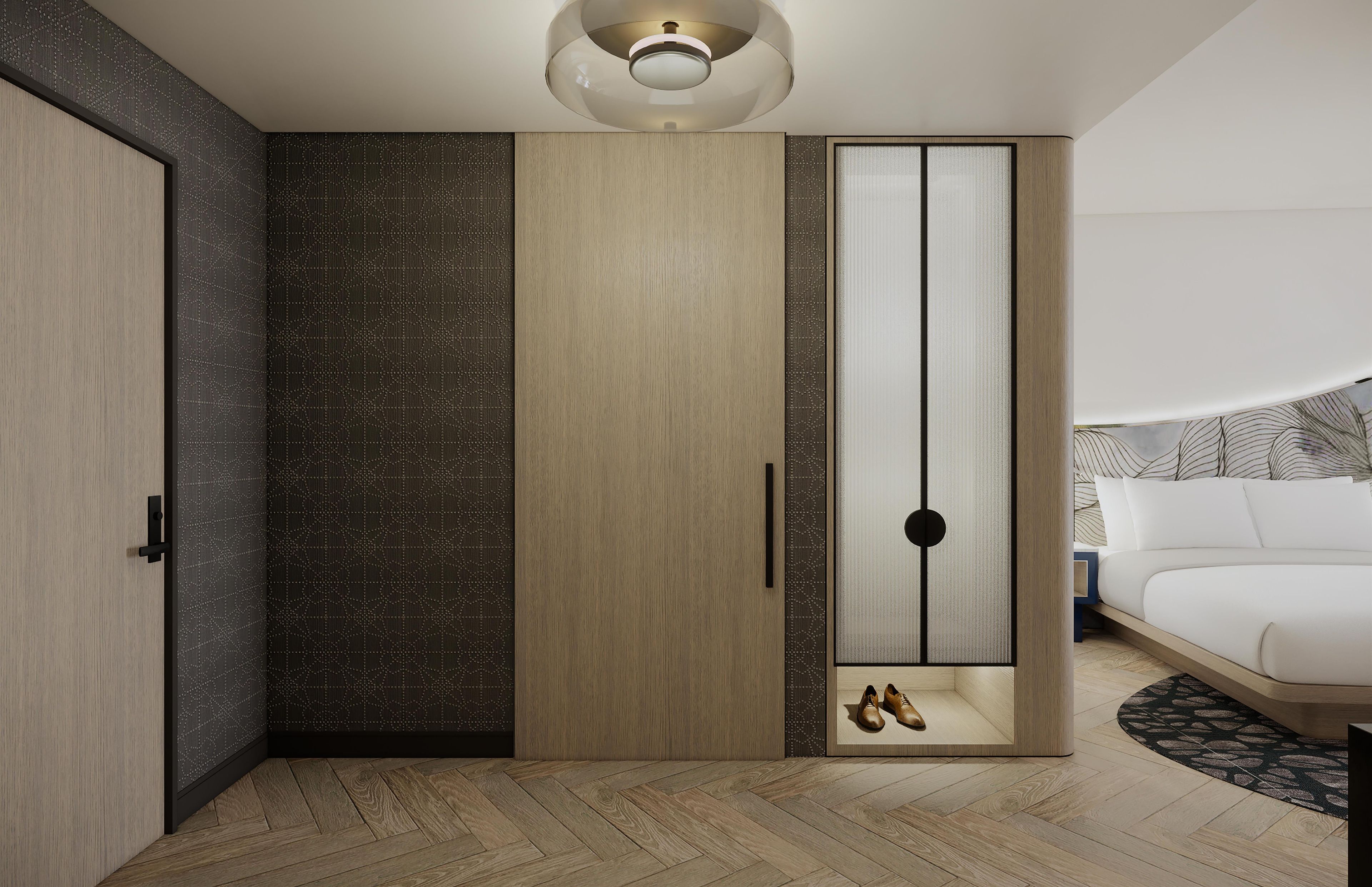 A modern bedroom with a wooden wardrobe, a bed, and a ceiling light fixture.