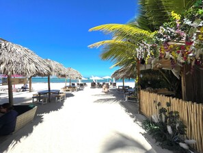 On the beach, white sand, sun-loungers, beach umbrellas