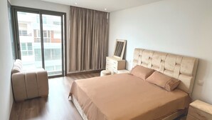 A modern bedroom with a large bed, a sofa, a dresser, and a mirror. - Modern sea view, near Hassan II Mosque, close to town center (Casablanca)