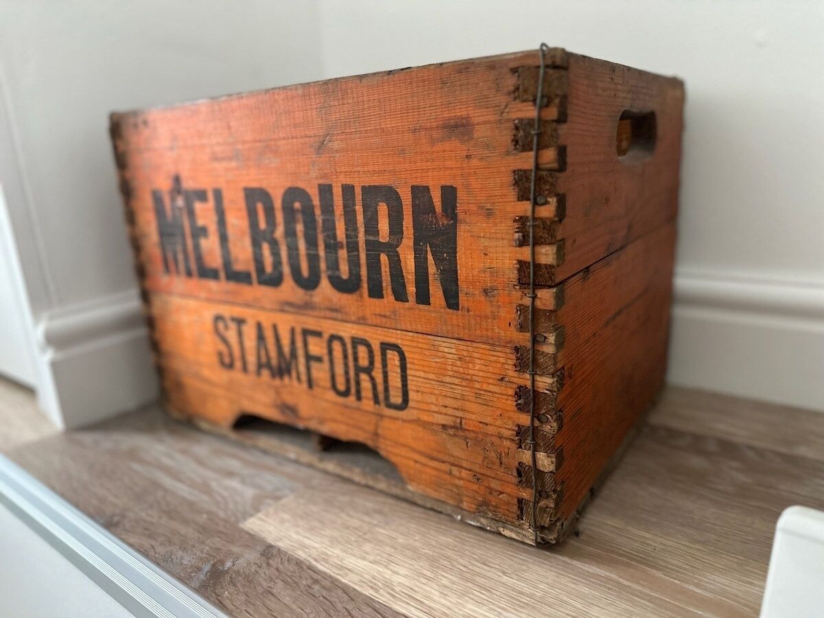 A wooden crate with 'MELBOURN STAMFORD' written on it.