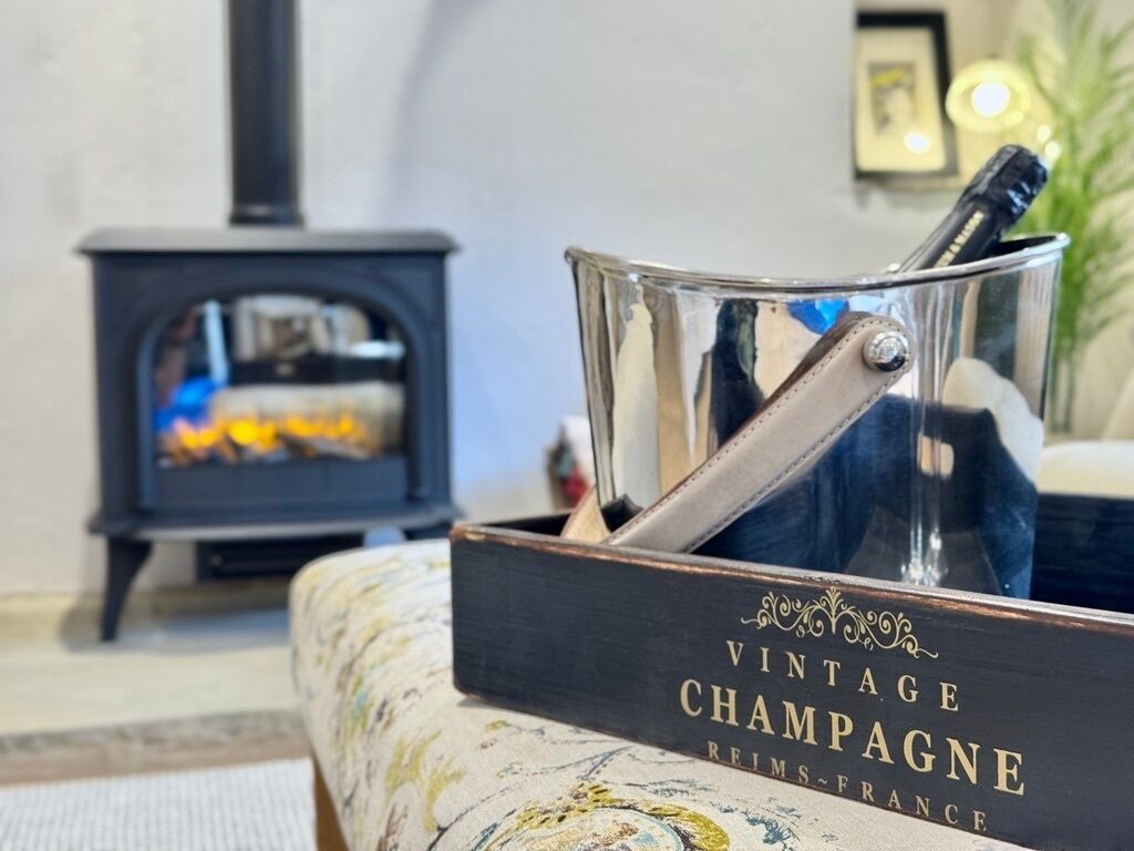 A vintage champagne box with a bottle in a glass holder.