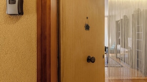 A wooden door with a house-shaped keyhole and a doorbell. - Andrea's home Bari (Bari)