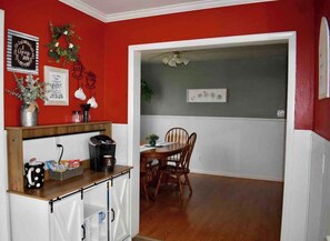 A kitchen with a coffee maker, a mug, and a plant on the counter. - Cozy Garden House (Adrian)
