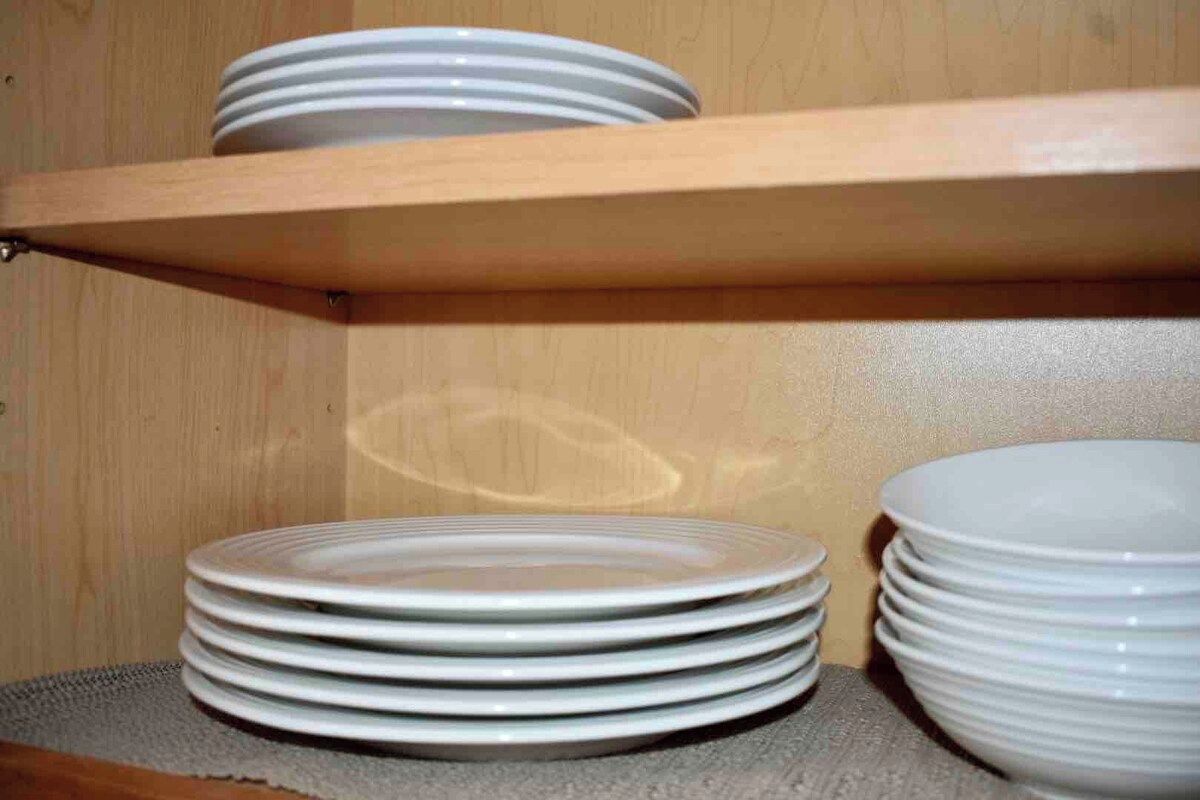 A shelf with stacked plates.