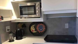 A compact kitchen with a microwave, a coffee maker, and a refrigerator. - Private Sedona retreat with private hot tub (Sedona)