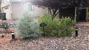 A sign indicating guest parking only, surrounded by gravel and small plants. - Private Sedona retreat with private hot tub (Sedona)