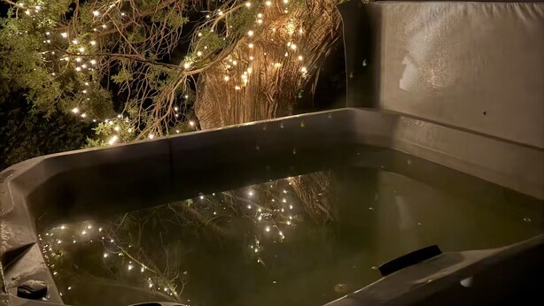 A hot tub surrounded by trees with string lights. - Private Sedona retreat with private hot tub (Sedona)