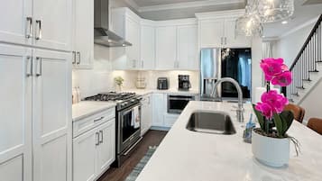 Fridge, stovetop, dishwasher, coffee/tea maker