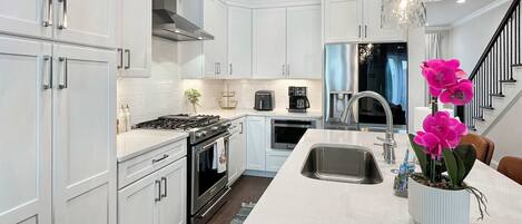 Fridge, stovetop, dishwasher, coffee/tea maker