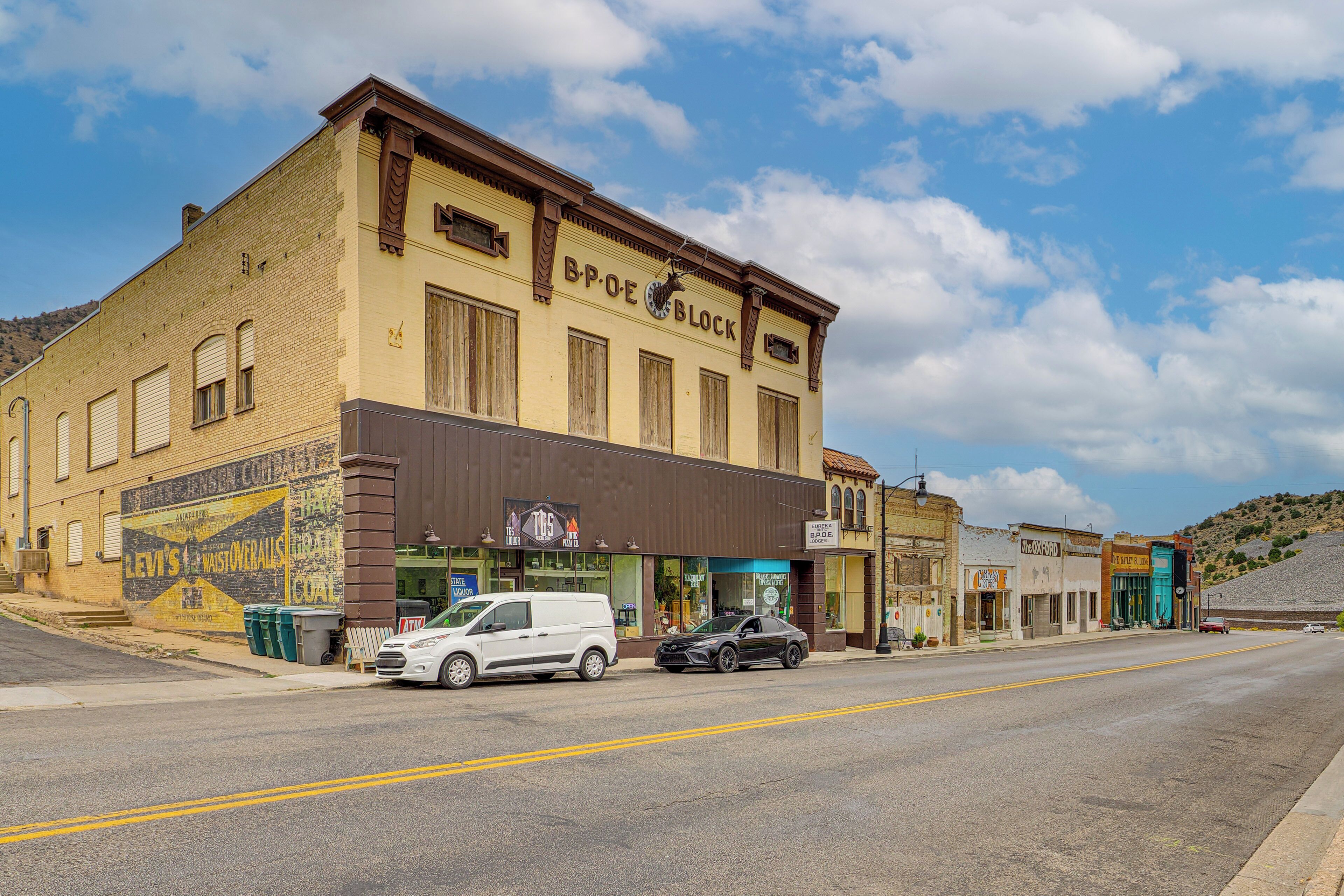 A street view with a building labeled "BPOE Block" and a white van parked in front.