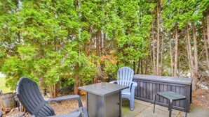 A patio with two Adirondack chairs, a table, and a built-in heater. - Walk to Marina: Dog-friendly Lake Ontario Studio (Sackets Harbor)