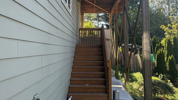 A wooden staircase leading to a balcony with a metal railing. - 2 Beds / 1 bath upgraded modern lower level home in NW Portland (portland)