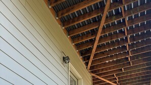 A wooden staircase leading to a door with a window, under a wooden roof structure. - 2 Beds / 1 bath upgraded modern lower level home in NW Portland (portland)