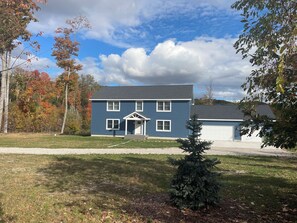 A two-story house with a front porch and a garage.