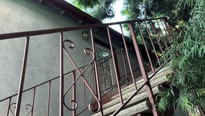 Eine Treppe mit Metallgeländern und Betonstufen, die zu einer Tür führt.