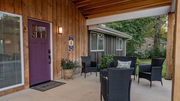 A wooden exterior with a purple door, wicker furniture, and a welcome mat. - King + 2 Queen Beds | 3 Smart TV`s | *WALK to LU* (Lynchburg)