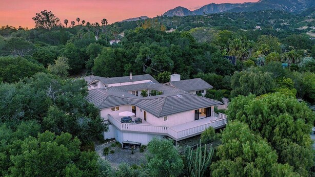 A modern house surrounded by dense greenery, with a large deck and multiple windows. - Beautiful Riviera Guest Suite in Private Forest, Conveniently Located Retreat (Santa Barbara)