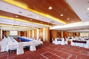 A conference room with a long table, white chairs, and a presentation screen. - Hotel Kukdo (Seoul)