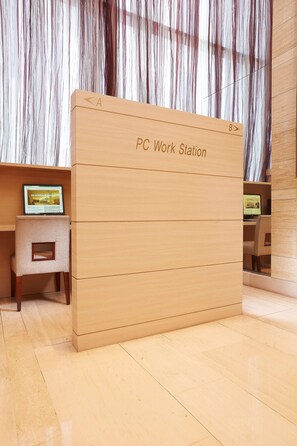 A PC Work Station with a laptop on a small table, a wooden desk, and a chair. - Hotel Kukdo (Seoul)