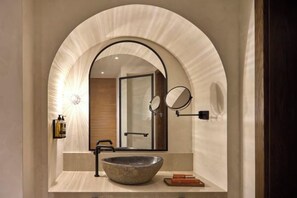 A bathroom with a large mirror, a vessel sink, and a towel rack. - Creta Maris Resort (Limenas Chersonisou)