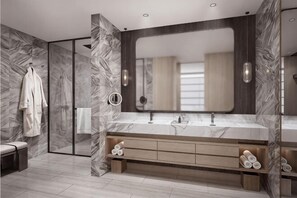 Ein modernes Badezimmer mit Marmorwaschtisch, großem Spiegel und begehbarer Dusche.