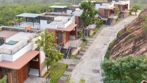 A modern residential complex with multiple buildings, a central pathway, and surrounding greenery. - Sky Hill Villa Suratthani (Surat Thani)