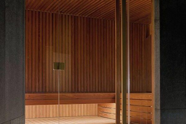 A wooden sauna with a bench and a small window. - W Amsterdam (Amsterdam)