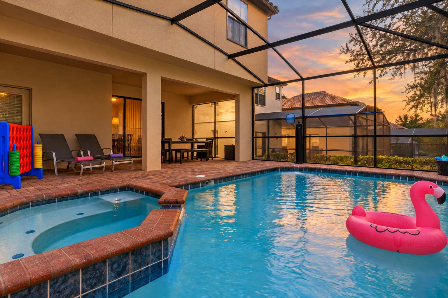 An indoor swimming pool with a hot tub, lounge chairs, and a flamingo float.