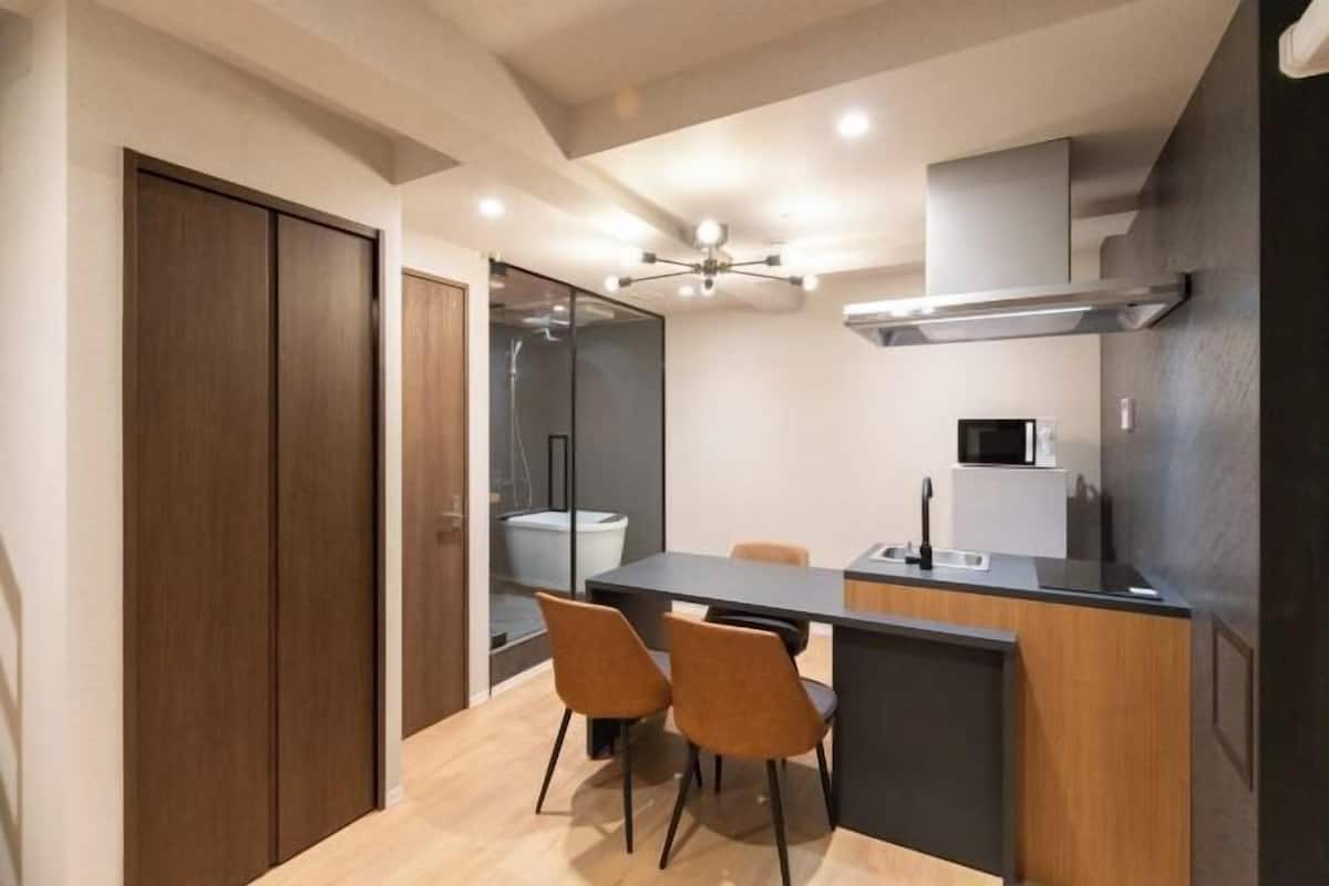 A compact kitchen with a central island, a microwave, and a sink.