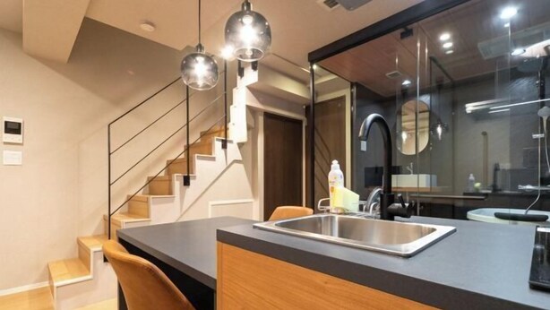 A modern kitchen with a built-in sink, wooden cabinets, and a staircase. - D-WASEDA (Tokyo)