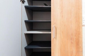 A wooden door with a metal handle and a shelf with a bird on it. - Kaike・Honcho detached house (Tokyo)