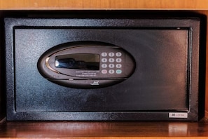 A black electronic device with a keypad and a screen, likely a control panel or interface, housed in a black case with a textured surface. - MCollection - Convenient City Stay in Iloilo Business Park (Iloilo City)