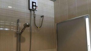 A shower area with a handheld showerhead and a wall-mounted control panel. - Phuket Town Budget House - Aircon Room #1 (Phuket)