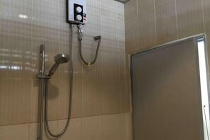 A shower area with a handheld showerhead and a wall-mounted control panel. - Phuket Town Budget House - Aircon Room #1 (Phuket)