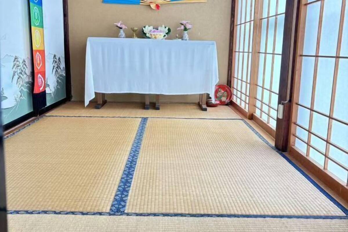 A tatami mat room with a table and decorative items.