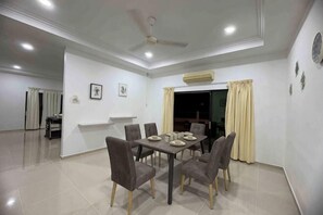 A dining area with a table set for six, chairs, a ceiling fan, recessed lighting, and a view of the outside. - 25 pax Golf Resort Private Villa (Padang Cina)