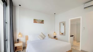 A modern bedroom with a large bed, wooden nightstands, and pendant lighting. - Moon Light Villa (Munggu)