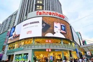 A building with a large advertisement for 'Kaw+Warhol' and 'UT'. - Berjaya Times Square 1BR Suite 5Pax Bukit Bintang Steps to Monorail (Kuala Lumpur)