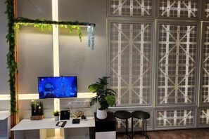 A modern room with a desk, a television, and a decorative plant. - Expressionz#KLCC#1BR#Skypool#NEW (Kuala Lumpur)