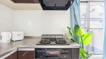 A kitchen with a stove, microwave, and a coffee maker.
