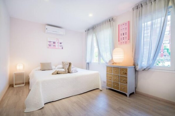 A bedroom with a bed, bedside table, dresser, and curtains. - Heart of Madrid II Museums Theatres Sights (Madrid)