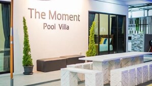 A modern interior with a sign reading "The Moment Pool Villa." - The Moment Pool Villa (Sattahip)