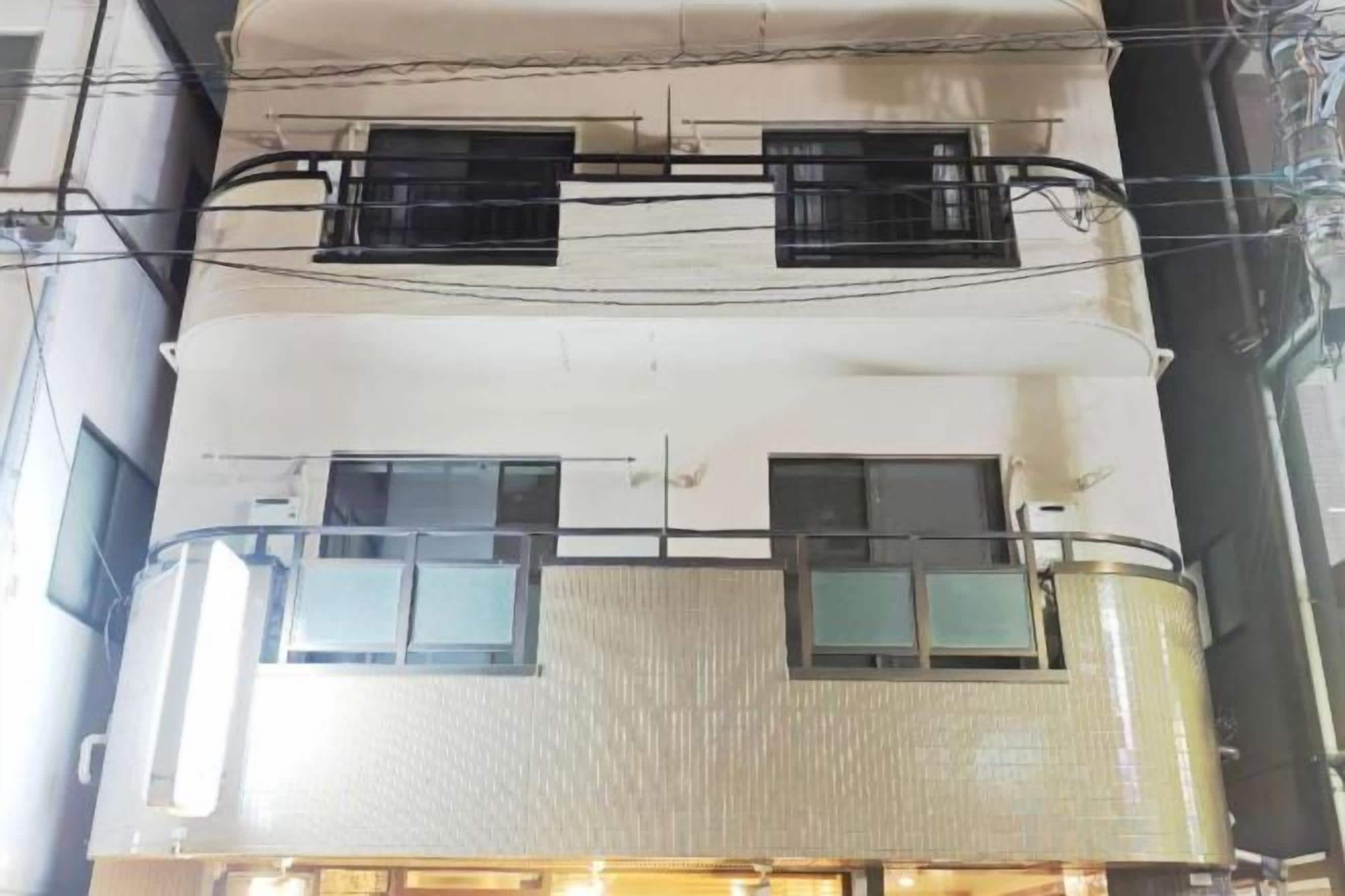 A multi-story building with balconies and windows.