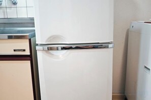 A white refrigerator with a freezer compartment, a built-in ice maker, and a water dispenser. - SUMMERSONG (Tokyo)